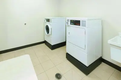 a laundry room with a washing machine and a washer at Hampton Inn Waynesburg in Waynesburg