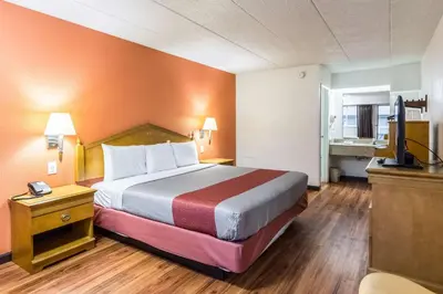 a hotel room with a bed and a television at Motel 6-Grove City, OH in Grove City