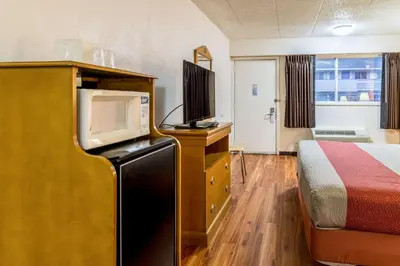 a hotel room with a bed and a tv at Motel 6-Grove City, OH in Grove City