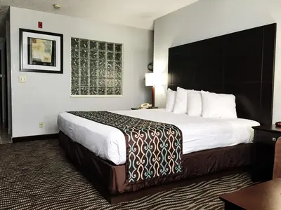 a hotel room with a large bed with white sheets at Best Western Executive Inn- Mount Gilead in Pulaskiville
