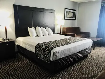 a hotel room with a large bed and a couch at Best Western Executive Inn- Mount Gilead in Pulaskiville