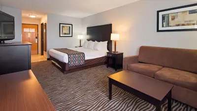 a hotel room with a bed and a couch at Best Western Executive Inn- Mount Gilead in Pulaskiville