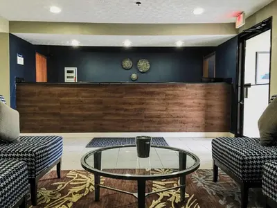 a lobby with a glass table and two chairs at Best Western Executive Inn- Mount Gilead in Pulaskiville