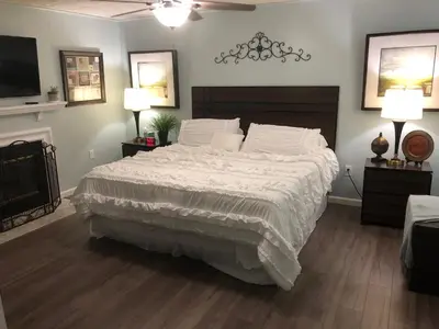 a bedroom with a large bed with white blankets and pillows at Liberty House in Bethany