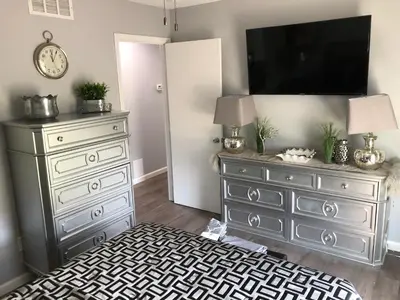 a bedroom with a dresser with a television on it at Liberty House in Bethany