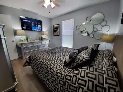 a bedroom with a large bed and a television at Liberty House in Bethany