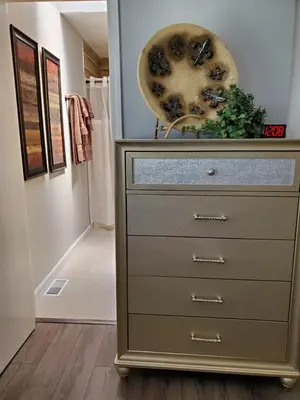 a dresser with a vase on top of it in a hallway at Liberty House in Bethany