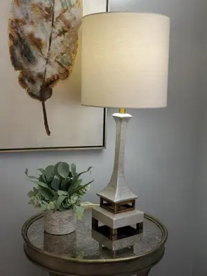 a lamp on a table with a plant on it at Liberty House in Bethany