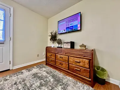 a living room with a flat screen tv on a wall at Jason's Attached Home in Monroe