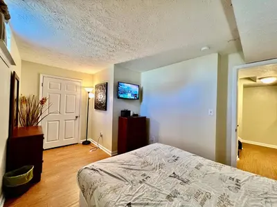 a bedroom with a bed and a tv on the wall at Jason's Attached Home in Monroe