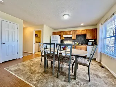 a kitchen and dining room with a table and chairs at Jason's Attached Home in Monroe