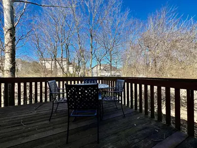 a table and chairs sitting on a wooden deck at Jason's Attached Home in Monroe