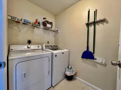 a small laundry room with a washing machine and candles at Jason's Attached Home in Monroe