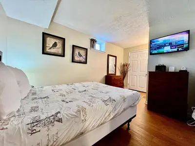 a bedroom with a bed and a tv on the wall at Jason's Attached Home in Monroe
