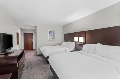 a hotel room with two beds and a flat screen tv at Holiday Inn Express & Suites Cross Lanes by IHG in Cross Lanes