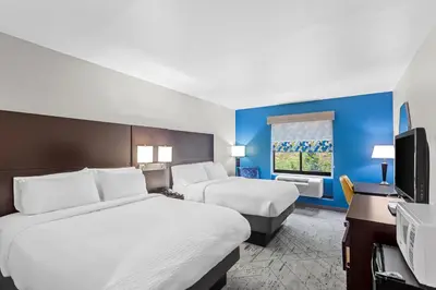 a hotel room with two beds and a desk at Holiday Inn Express & Suites Cross Lanes by IHG in Cross Lanes