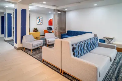 a waiting room with a couch and two chairs at Holiday Inn Express & Suites Cross Lanes by IHG in Cross Lanes