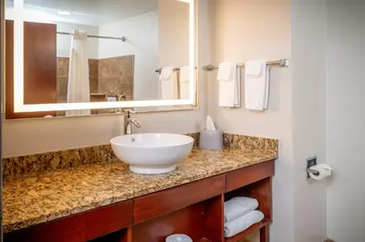 a bathroom with a white sink and a mirror at Holiday Inn Express & Suites Cross Lanes by IHG in Cross Lanes