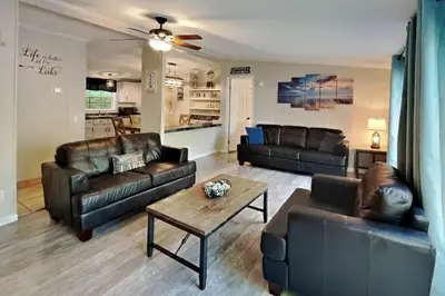 a living room with leather furniture and a table at Put-in-Bay Island Club #27 in Put-in-Bay