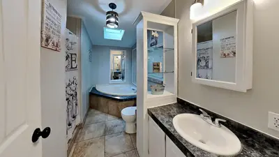 a bathroom with a sink and a toilet and a tub at Put-in-Bay Island Club #27 in Put-in-Bay