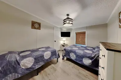 a bedroom with two beds and a flat screen tv at Put-in-Bay Island Club #27 in Put-in-Bay