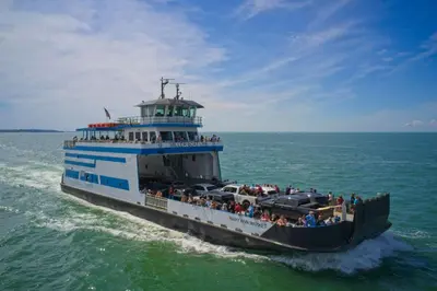 a ferry boat filled with people on the water at Put-in-Bay Island Club #27 in Put-in-Bay