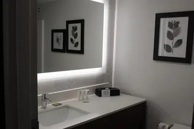 a bathroom with a sink and a mirror at Country Inn & Suites by Radisson, Dunbar - Charleston in Dunbar