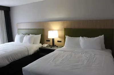 a hotel room with two beds and a phone at Country Inn & Suites by Radisson, Dunbar - Charleston in Dunbar