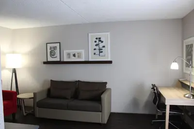 a living room with a couch and a table at Country Inn & Suites by Radisson, Dunbar - Charleston in Dunbar