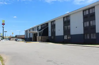 an empty parking lot in front of a hotel at Country Inn & Suites by Radisson, Dunbar - Charleston in Dunbar