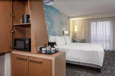 a hotel room with a bed and a tv at Courtyard Cincinnati Mason in Mason