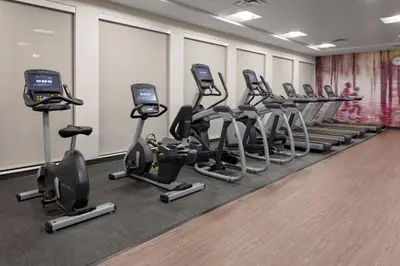 a row of exercise bikes in a gym at Courtyard Cincinnati Mason in Mason
