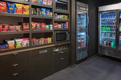 a kitchen with two refrigerators and a refrigerator at Courtyard Cincinnati Mason in Mason