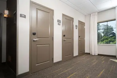 a row of doors in a hallway with a window at Staybridge Suites Florence - Cincinnati South by IHG in Florence