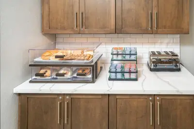 a kitchen with a counter with bread and other foods at Staybridge Suites Florence - Cincinnati South by IHG in Florence