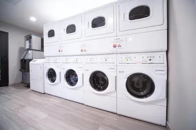 a stack of white washing machines in a laundry room at Staybridge Suites Florence - Cincinnati South by IHG in Florence