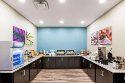a kitchen with a blue wall and a counter at Sleep Inn Winfield - Teays Valley in Hurricane