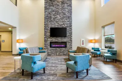 a lobby with chairs and a fireplace with a tv at Sleep Inn Winfield - Teays Valley in Hurricane