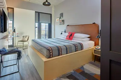 a bedroom with a bed with a red pillow at Moxy Columbus Short North in Columbus