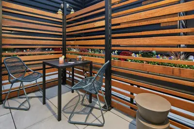 a room with a table and chairs and a wooden wall at Moxy Columbus Short North in Columbus