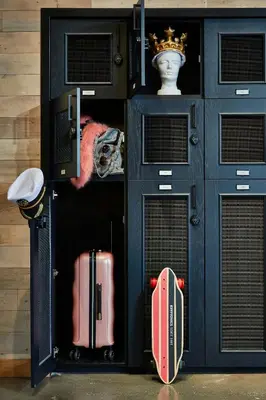 a black cabinet with two suitcases and a pink suitcase at Moxy Columbus Short North in Columbus