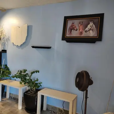 a room with two tables and a picture of horses on the wall at Travel Inn in Delaware