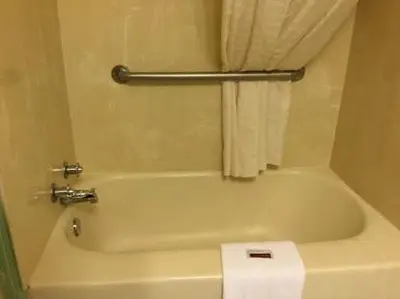 a white bath tub in a bathroom with a towel at FALLS INN in Newton Falls