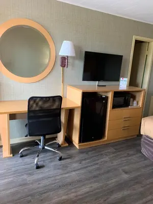 a room with a desk and a chair and a mirror at FALLS INN in Newton Falls