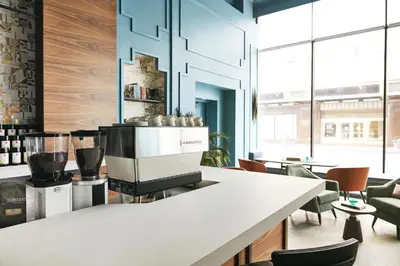 a kitchen with a counter with a coffee machine at Kinley Cincinnati Downtown, a Tribute Portfolio Hotel in Cincinnati