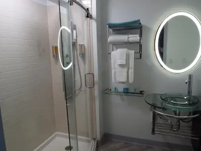 a bathroom with a shower and a sink and a mirror at Athens Central Hotel in Athens
