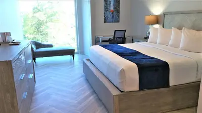 a hotel room with a large bed and a desk at Athens Central Hotel in Athens