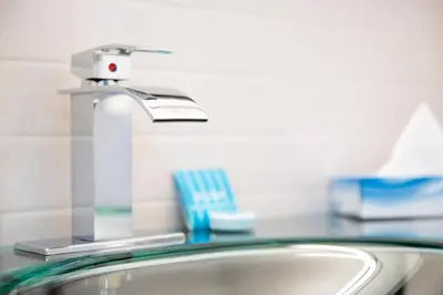 a bathroom sink with a faucet and a toothbrush at Athens Central Hotel in Athens