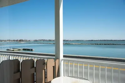 a balcony with a view of the water at West Bank Inn in Celina
