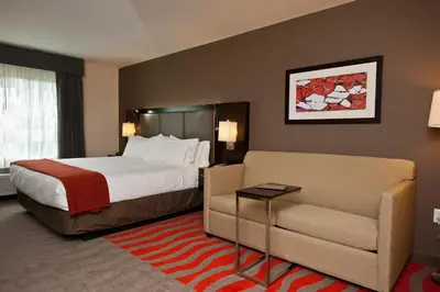 a hotel room with a bed and a couch at Holiday Inn Express & Suites Columbus - Easton Area by IHG in Gahanna